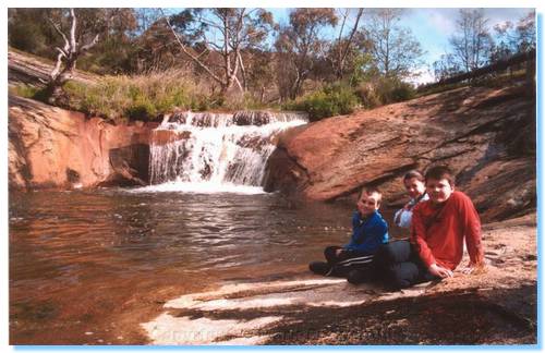 Kids by a rock pool under Spring Creek Bridge
